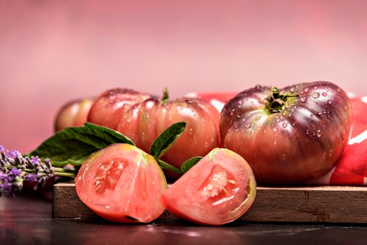 Beautiful fresh tiger tomatoes on dark background