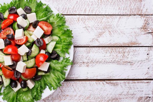 Greek salad and wooden copy space - Stock image