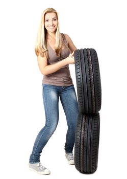 Young sexy girl with car wheels, isolated on white.