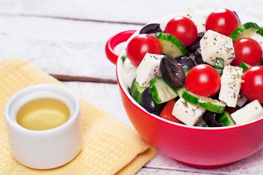 Greek salad in red boul and copy space - Stock image