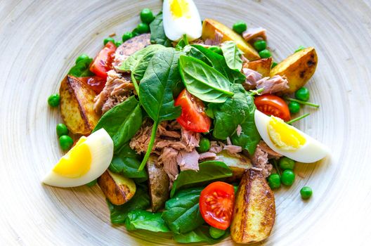 Cooking tuna salad on the wooden plate. Stock image.