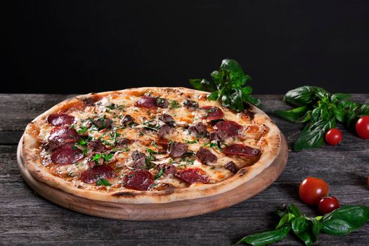 Pepperoni Pizza with salami, mushrooms , meat , beef, cheese and green onions on the wooden background. Top view.