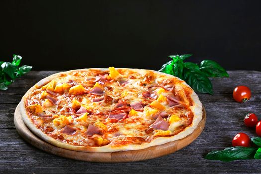 Delicious fresh Pizza with pineapple, bacon and cheese mozzarella on the wooden. Top view.