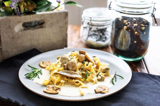 Tagliatelle vegetarian Pasta Dish with Mushrooms on the wooden background