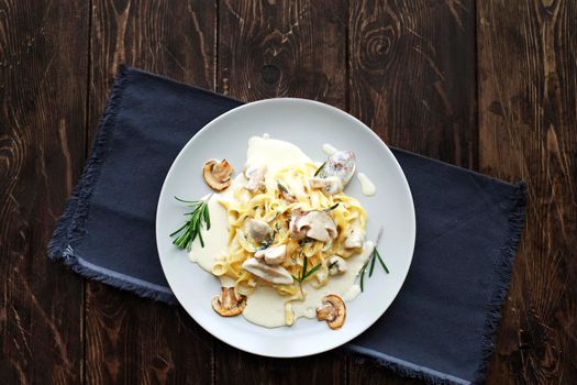 Tagliatelle vegetarian Pasta Dish with Mushrooms on the wooden background
