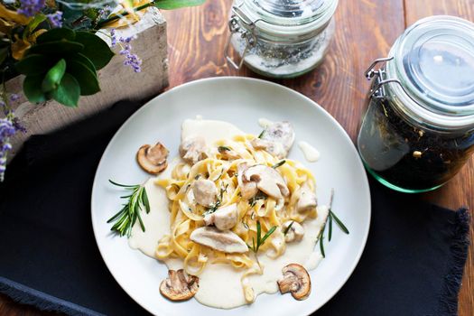 Tagliatelle vegetarian Pasta Dish with Mushrooms on the wooden background