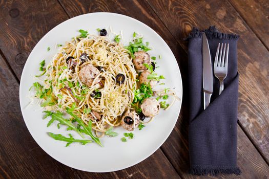 Pasta with meatballs, anchovies and olives. Top view