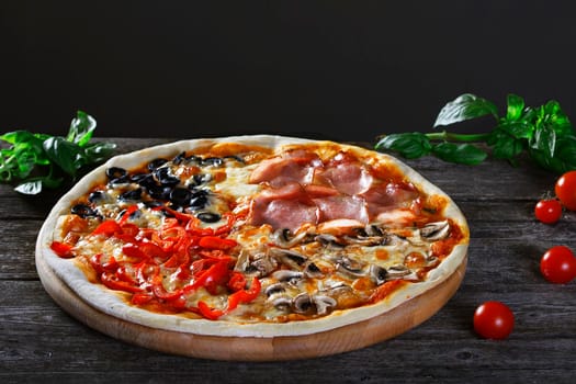 Assorted 4 parts Delicious fresh Pizza with bacon, mushrooms, peppers and olives on the wooden background. Top view.