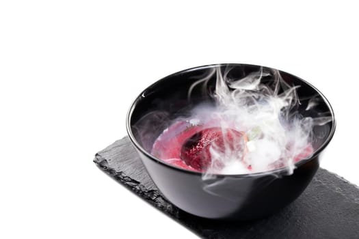 Molecular Cuisine. Delicious modern soup with beetroot. Isolated on white. Stock image.