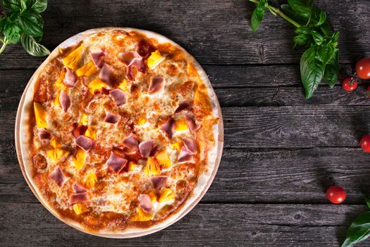 Delicious fresh Pizza with pineapple , bacon and cheese mozzarella on the wooden. Top view.