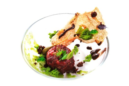 Molecular modern cuisine. Chips Pigskin with tartare or carpaccio of beef. Stock image. Isolated on white.