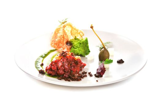 Molecular modern cuisine. Chips Pigskin with tartare or carpaccio of beef. Stock image. Isolated on white.