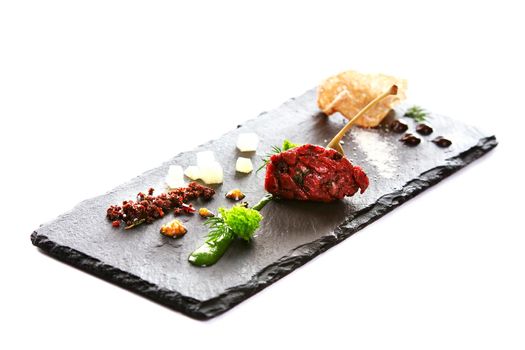 Molecular modern cuisine. Chips Pigskin with tartare or carpaccio of beef. Stock image. Isolated on white.