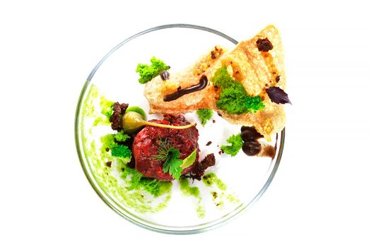 Molecular modern cuisine. Chips Pigskin with tartare or carpaccio of beef. Stock image. Isolated on white.