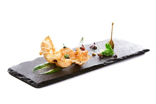 Molecular modern cuisine. Chips Pigskin with tartare or carpaccio of beef. Stock image. Isolated on white.