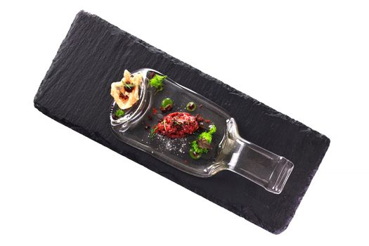 Molecular modern cuisine. Chips Pigskin with tartare or carpaccio of beef. Stock image. Isolated on white.