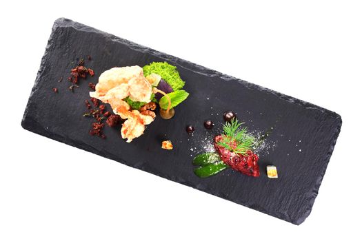 Molecular modern cuisine. Chips Pigskin with tartare or carpaccio of beef. Stock image. Isolated on white.