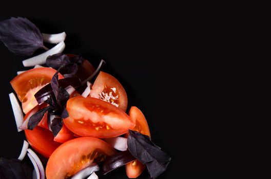 Slices of tomato. Vegetables on Black background with copy space