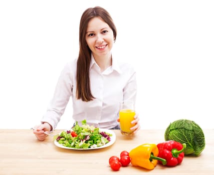 Woman with plate of salad, orange juice and vegetables, isolated on white.