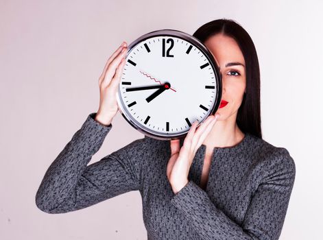 Creative fashion glamourous woman holding clock. isolated on white background