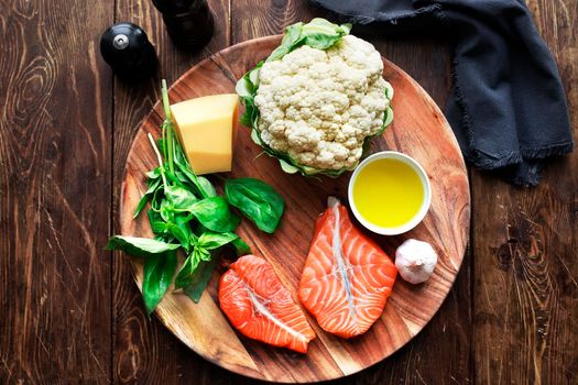 Raw humpback salmon steaks, rustic wooden background, above view. Fillet with fresh ingredients for tasty cooking and frying pan. Top view. Healthy and diet food concept.