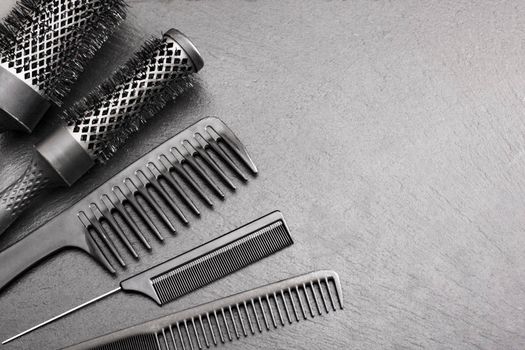 Salon Hairdresser Accessories, Comb and brashing for cutting hair on a black background