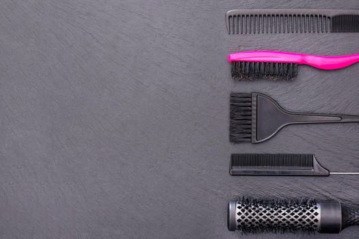 Salon Hairdresser Accessories, pink Comb, application brush, brashing for cutting hair or colored on a black background