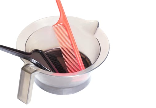 Salon mixing bowl, application brush and sectioning comb for hair dye or colored highlights. Isolated on white