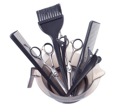 Salon mixing bowl, application brush, shears and sectioning comb for hair dye or colored highlights. Isolated on white
