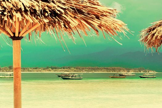 Straw umbrella on a sandy beautiful beach in island.