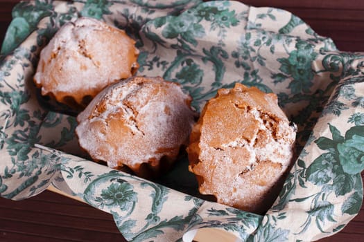 Muffin cakes on a blue tablecloth. Stock image.