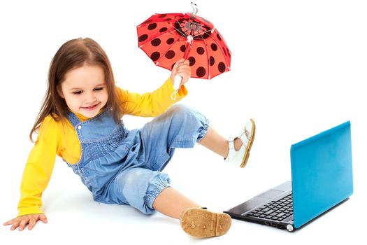 Portrait of a cute little girl using laptop. Horizontal shot. Isolated on white.