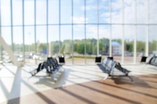 Office building or university library lobby hall reading area blur background with blurry school hallway corridor interior view to empty corridor entrance, glass wall and exterior light illumination