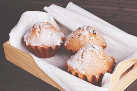 Muffin cakes on a white tablecloth. Stock image.