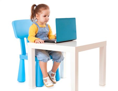 Portrait of a cute little girl using laptop. Horizontal shot. Isolated on white.