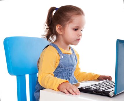 Portrait of a cute little girl using laptop. Horizontal shot. Isolated on white.