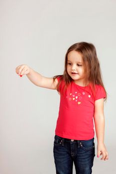 Girl holds something from her hand. Copy space.