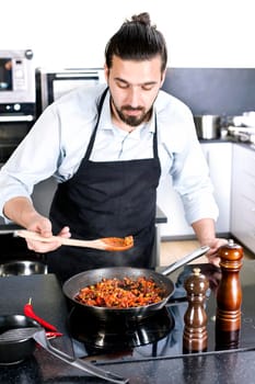 Chef preparing dishes in a frying pan. Cooking. Stock image