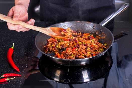 Chef preparing dishes in a frying pan. Cooking.