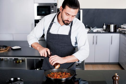 Chef preparing dishes in a frying pan. Cooking. Stock image