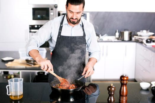 Chef preparing dishes in a frying pan. Cooking. Stock image