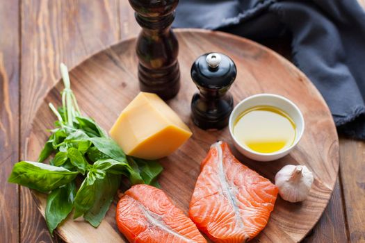 Raw humpback salmon steaks, rustic wooden background, above view. Fillet with fresh ingredients for tasty cooking and frying pan. Top view. Healthy and diet food concept.