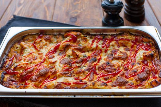 Italian Food. Hot tasty lasagna in ceramic casserole dish on Wooden Table