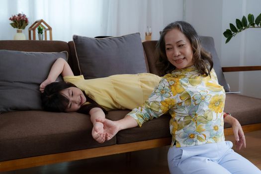 Asian portrait, grandma and granddaughter doing leisure activities and hugging to show their love and care for each other.