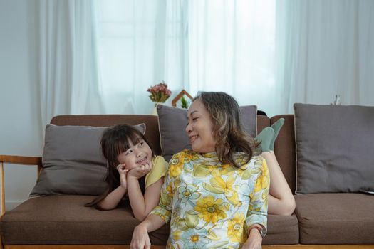 Asian portrait, grandma and granddaughter doing leisure activities and hugging to show their love and care for each other.