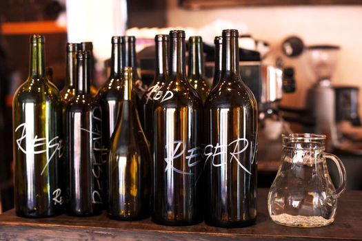 Empty decorative bottles for Red and White Wine in the bar or restaurant - Stock image