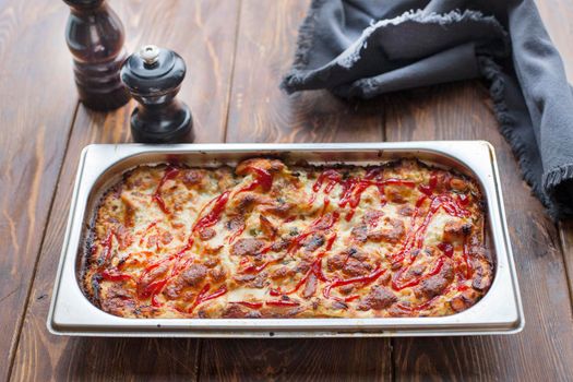 Italian Food. Hot tasty lasagna in ceramic casserole dish on Wooden Table