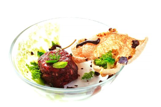 Molecular modern cuisine. Chips Pigskin with tartare or carpaccio of beef. Stock image. Isolated on white.