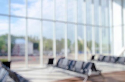 Office building or university library lobby hall reading area blur background with blurry school hallway corridor interior view to empty corridor entrance, glass wall and exterior light illumination