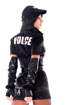 Portret of beautiful sexy policewoman with handcuffs in a black uniform that aiming a gun. Iisolated on white.